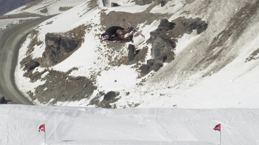 A man does a ski jump on a hill