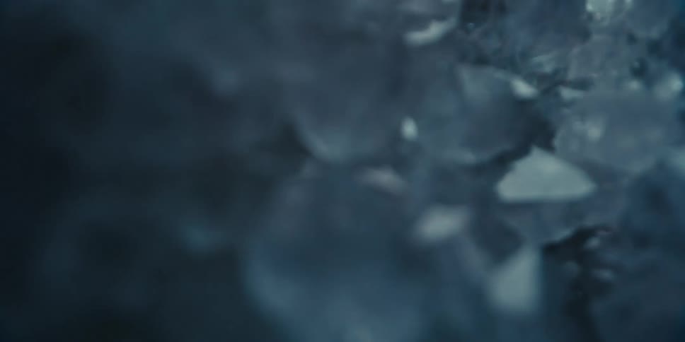 Abstract close up of fragmented ice reflecting flashing lights