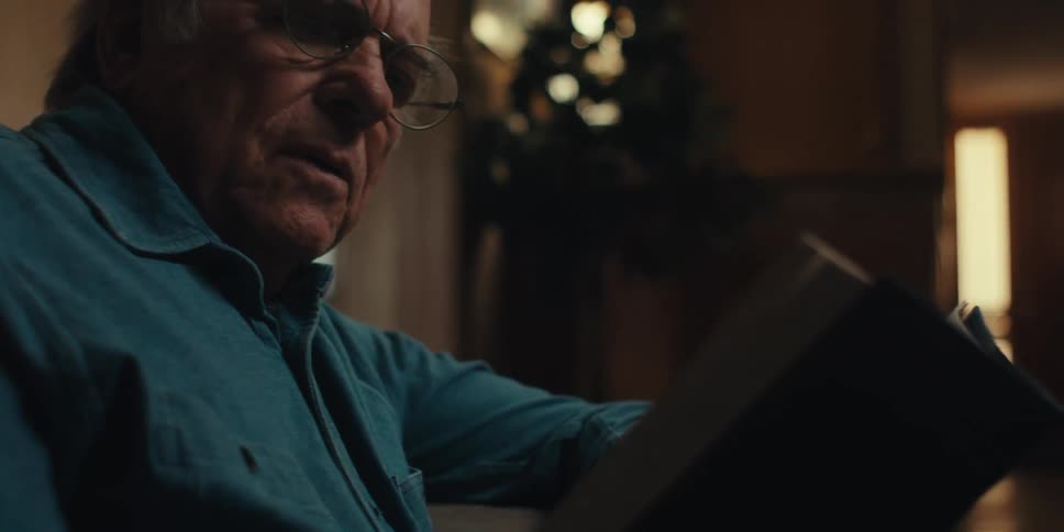 A clip of an elderly man reading indoor
