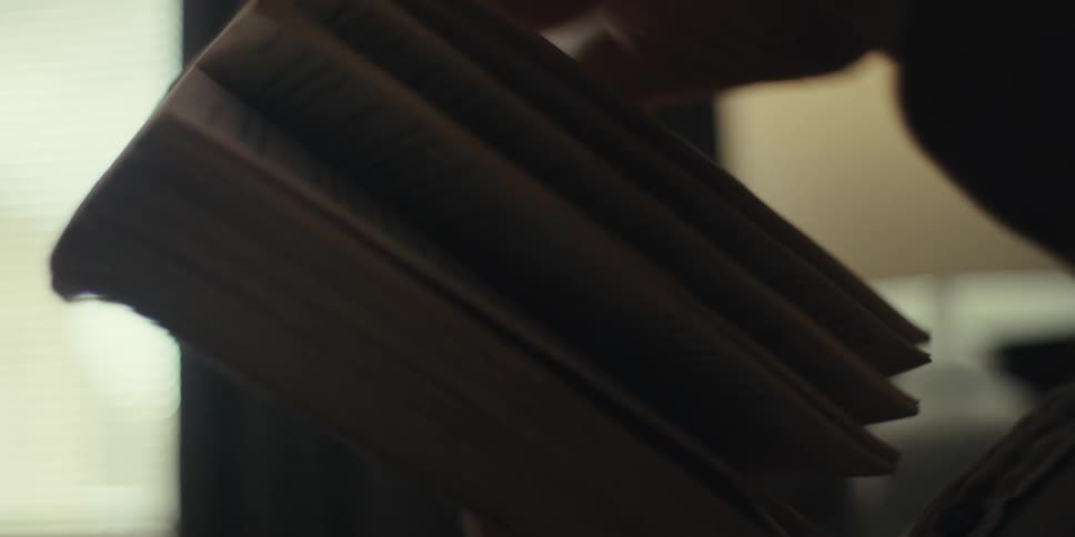 A man flips through pages of a book