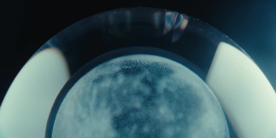 Wet foggy glass in a porthole faces outward during the day