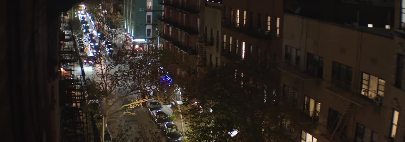 Street of an urban city at night with vehicle traffic