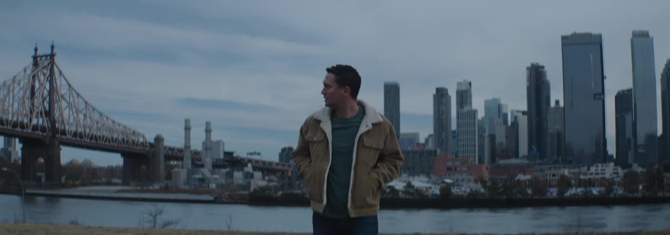 A man walks away form the skyline on a cloudy day