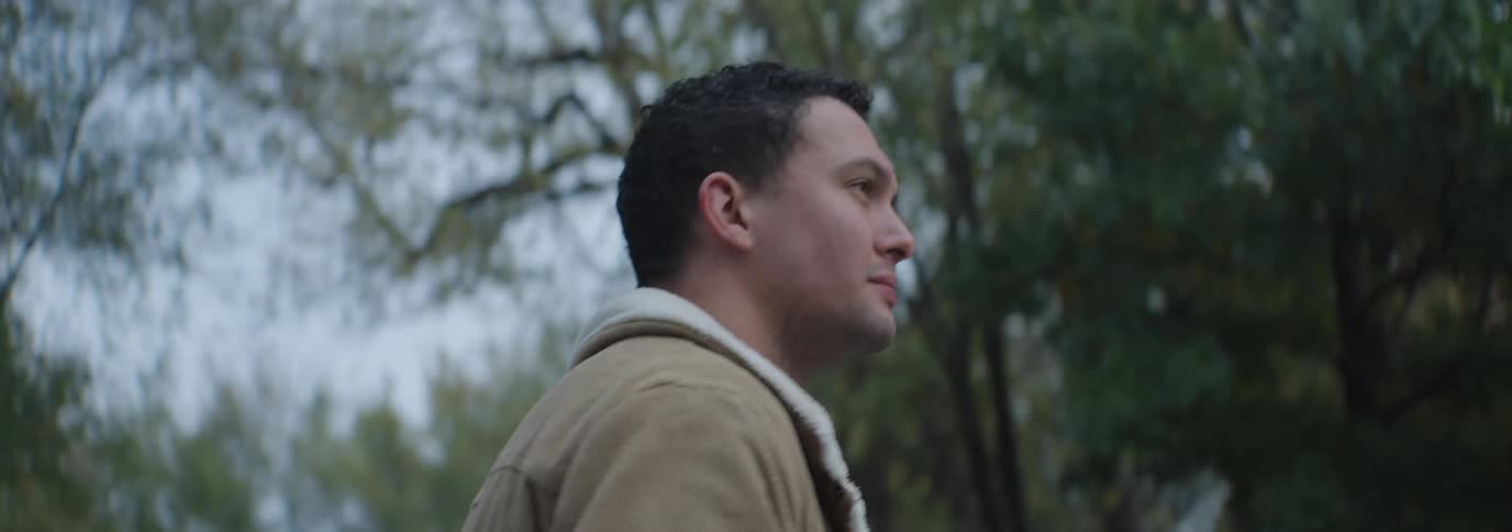Man walking outdoors in a place surrounded by trees