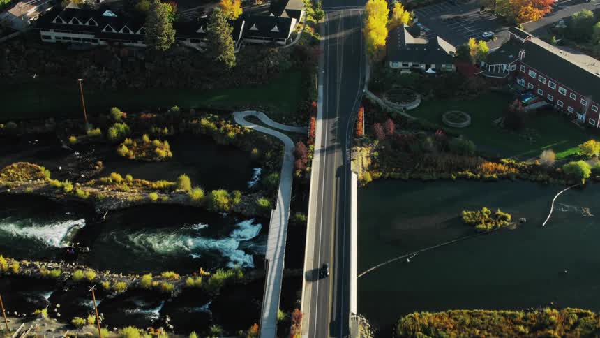 Cars drive over the through the suburban town