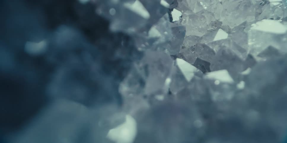 Abstract close up of fragmented ice reflecting flashing lights