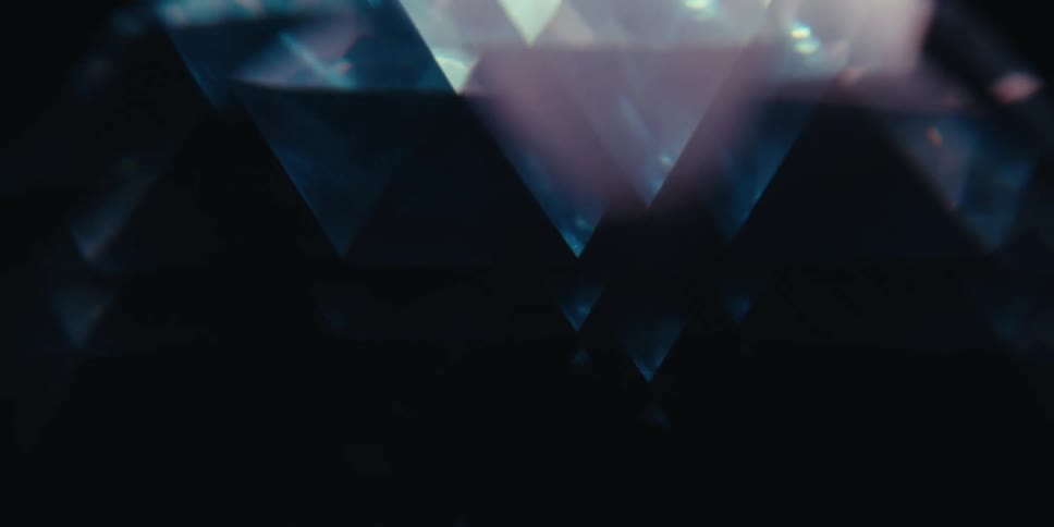 Abstract image of a blue gemstone with sharp facets reflecting light