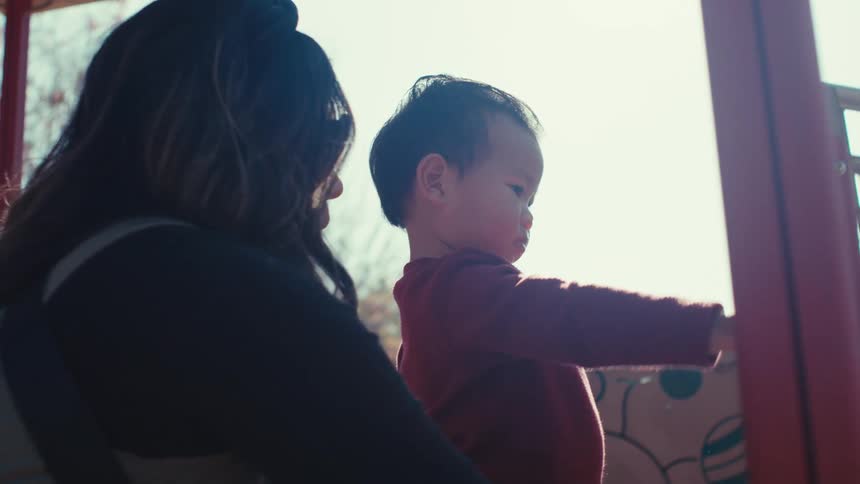 Mother with her little son in a playground