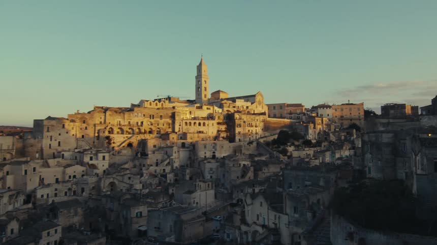 Historic town with classical architecture and a church pillar in the background