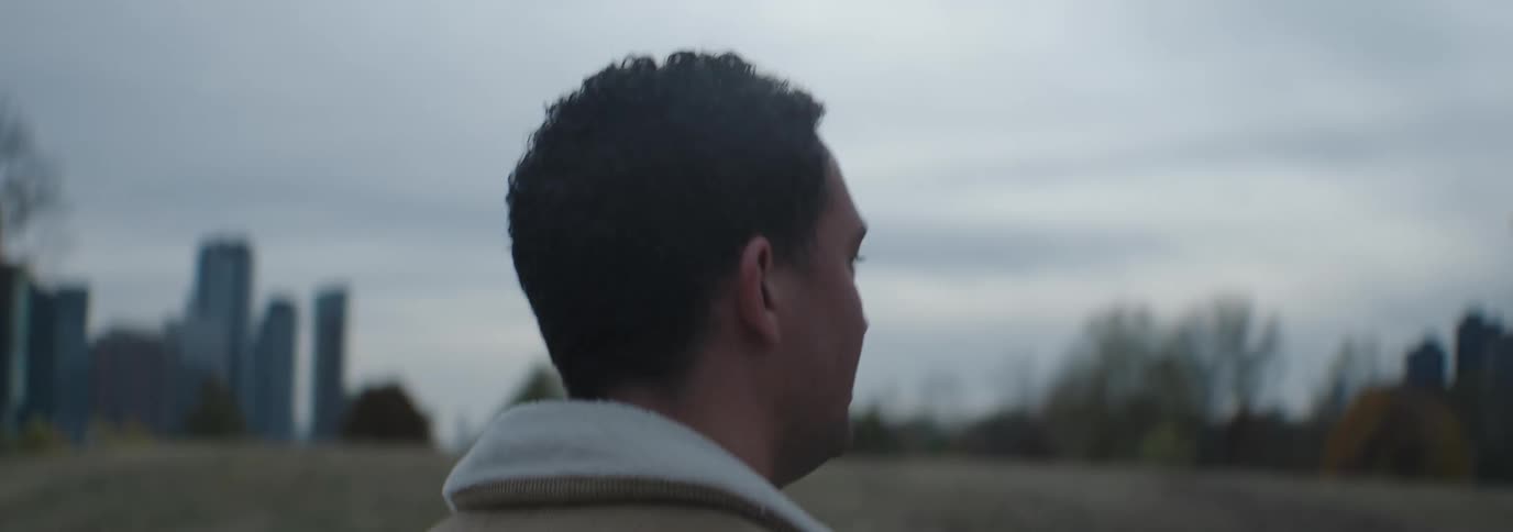 A man is talking and walking in the park