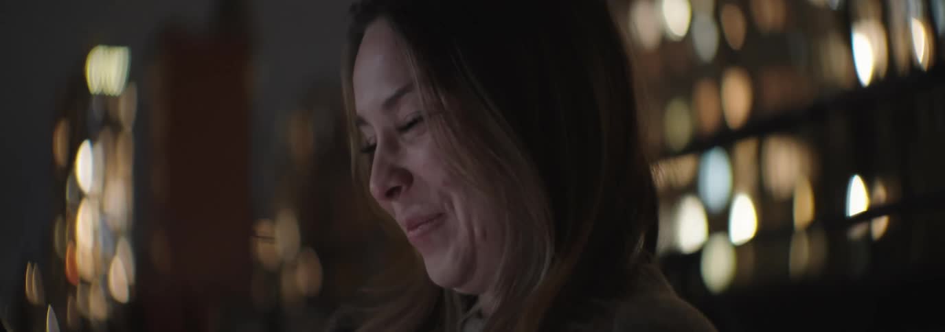 A clip of a lady smiling at her phone