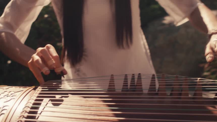Concentrated woman outdoors playing a musical instrument