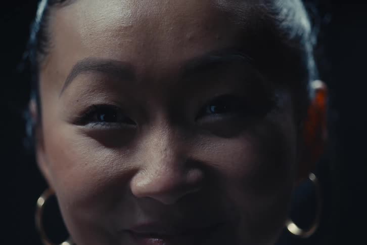 Closeup of hoop earring wearing woman smiling