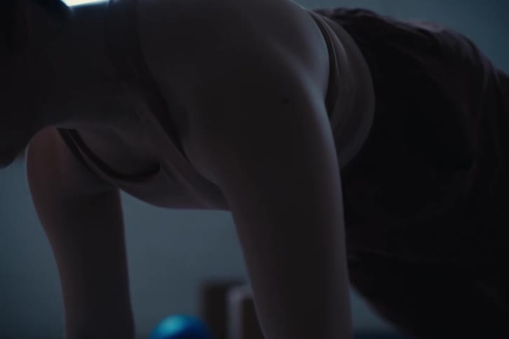 A woman performing a yoga pose bending backwards with her back arched