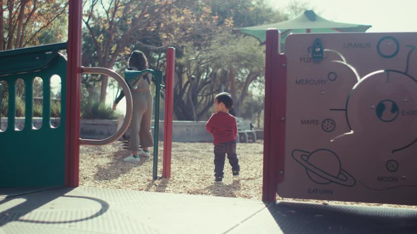Little boy playing in a playground during the day