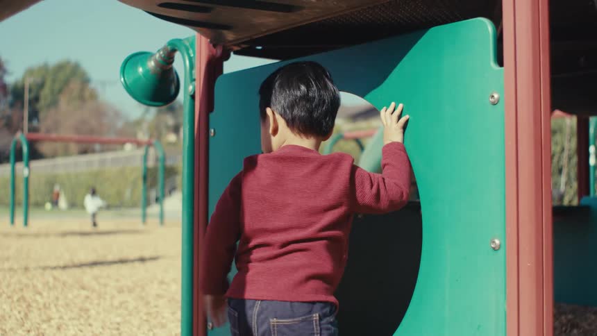 Little boy playing in an outdoor playground