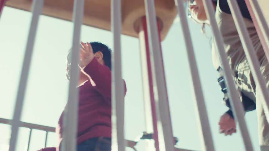 Mother and son together on an outdoor toy