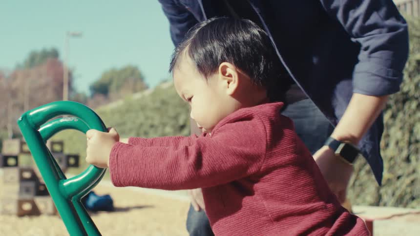 Father playing with his son in a sand playground