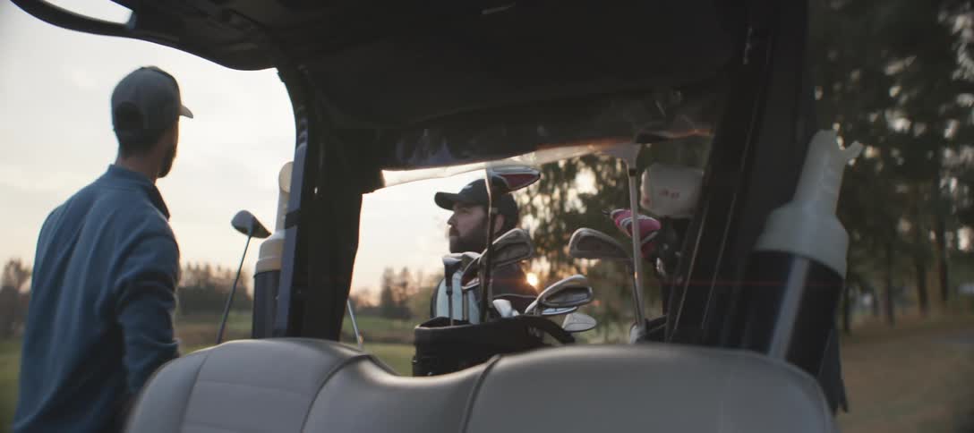 A clip of men getting set for a golf game