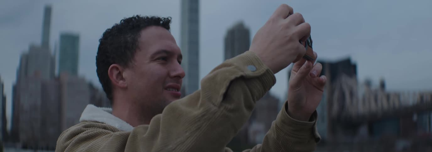 Man outdoors taking pictures with his smartphone