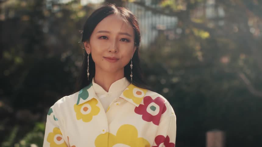 A portrait of beautiful young woman smiles in the garden