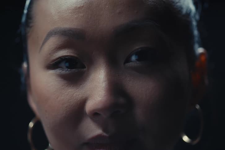 Face of a woman in a dark indoor location