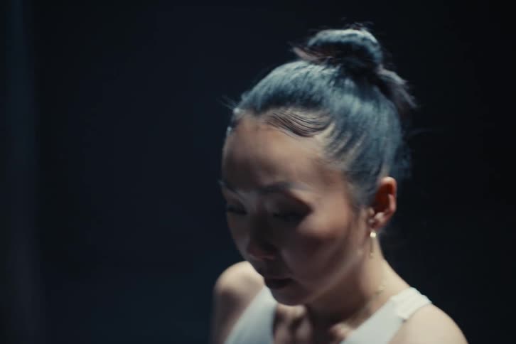 Concentrated woman practicing boxing punches on a punching bag