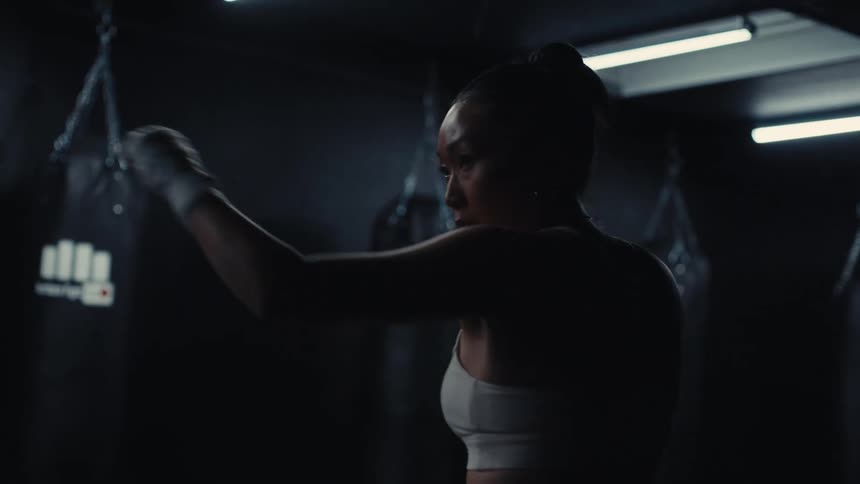 Woman in a gym practicing boxing punches