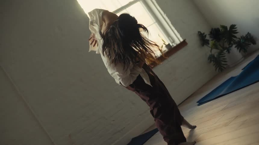Woman dancing in a solo performance in a room