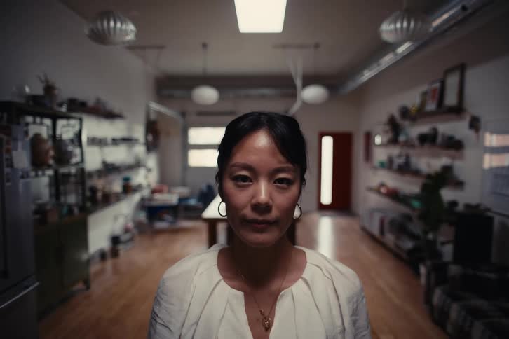 Woman walking in a room with a white blouse