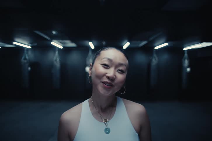 Portrait of a woman wearing a sleeveless blouse and with a happy facial expression