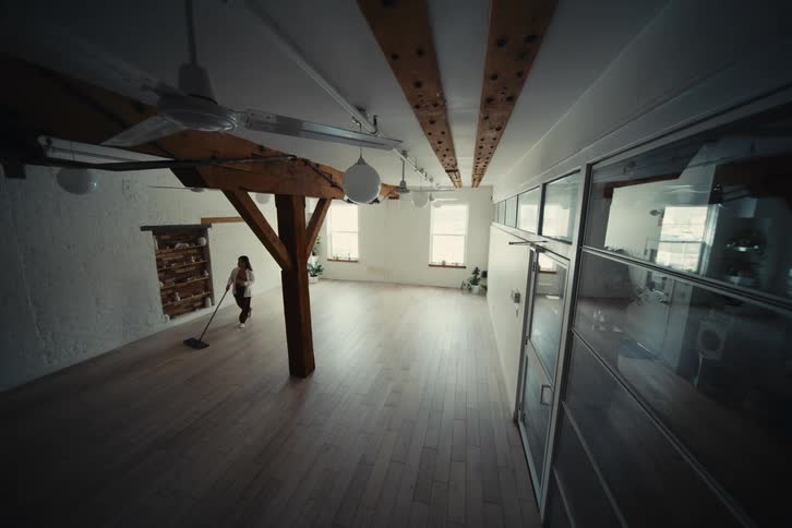 Woman cleaning a laminate floor in a room