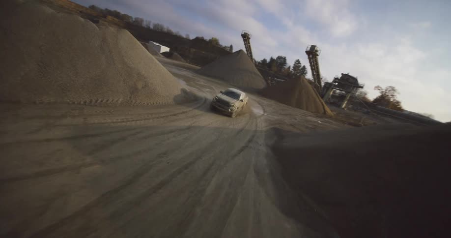 A rugged truck maneuvering around a sand quarry