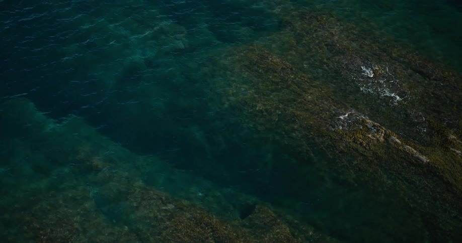 The ocean water covers the rocks