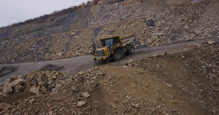 A dump truck is parked in the rock quarry