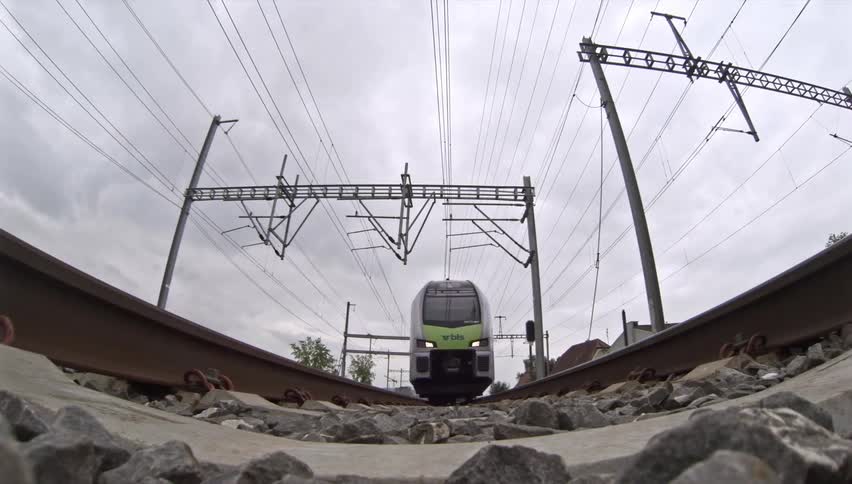 Train passing through the rails outdoors during daytime