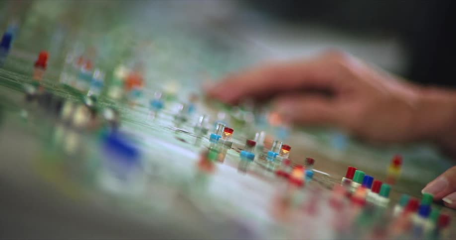 Pair of hands operating buttons on a panel
