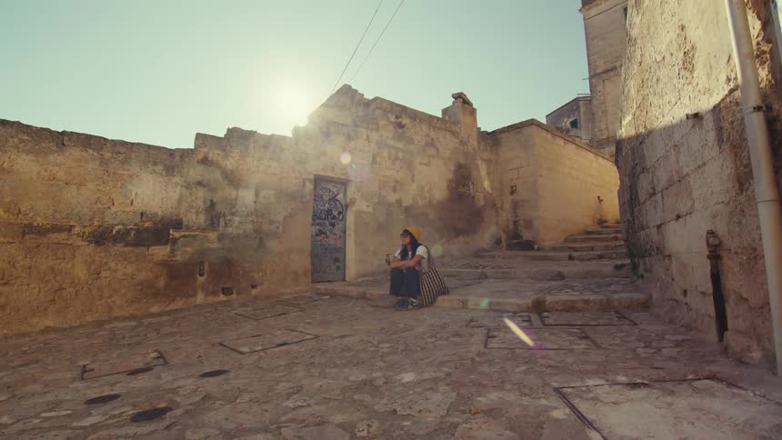 A footage of a person sitting outdoor