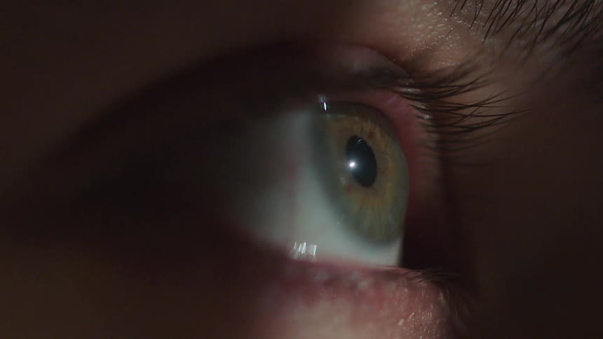Person with hazel eyes opens their eye and their pupil shrinks in the presence of light