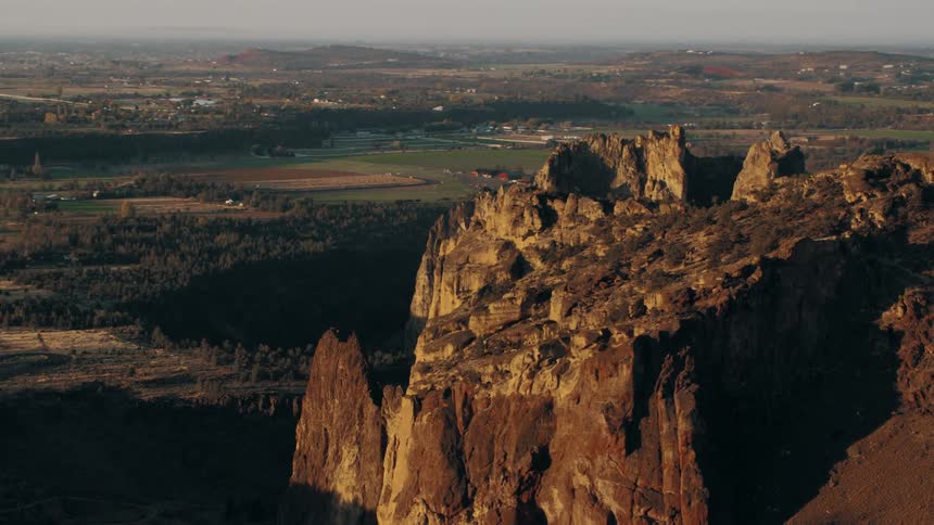 An aerial view of a mountainous environment with huge stone rock formations in a rural region