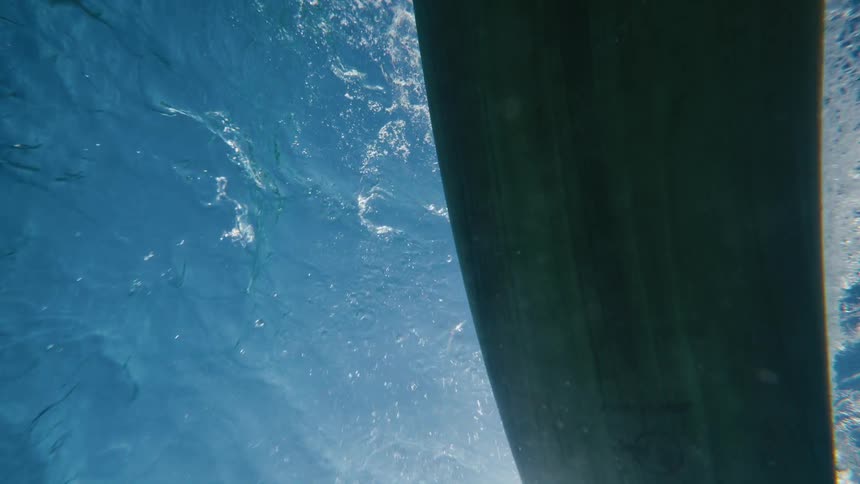 Underwater surfboard drifting on the sea outdoors during daytime