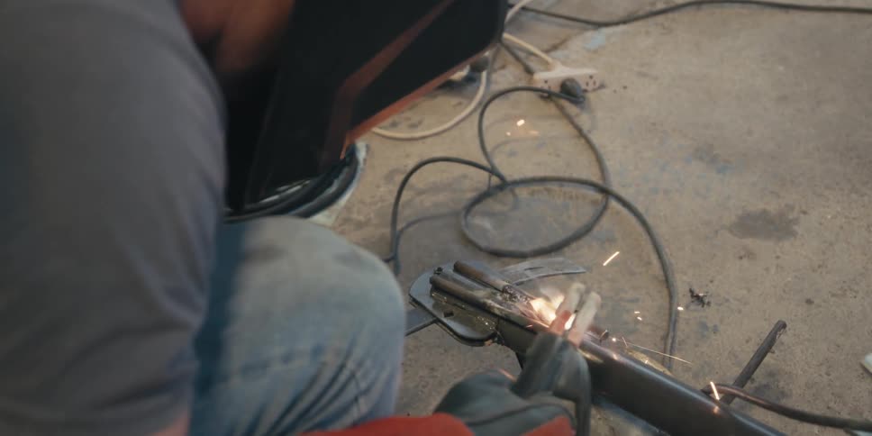 A person welds iron