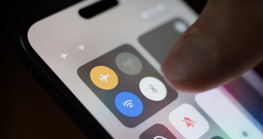 Person sets their smartphone into airplane mode