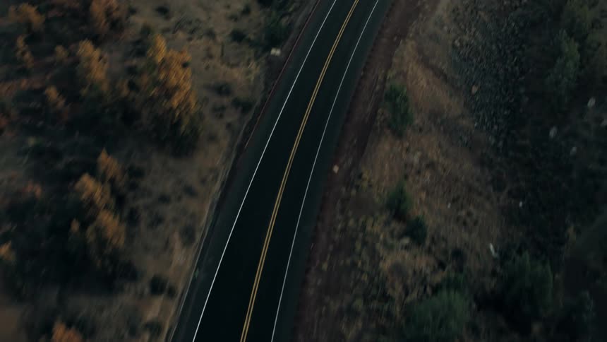 Aerial view shows a rural area of flatland with a road running through the middle