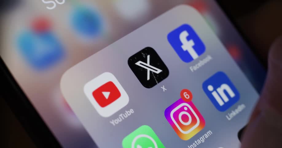 A finger is tapping the instagram icon on a smartphone screen