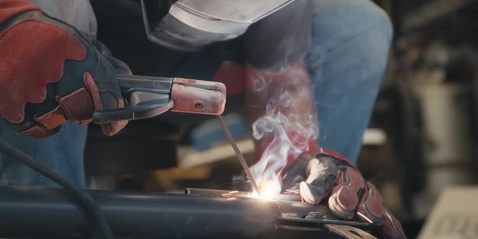 A welder is using a torch on metal