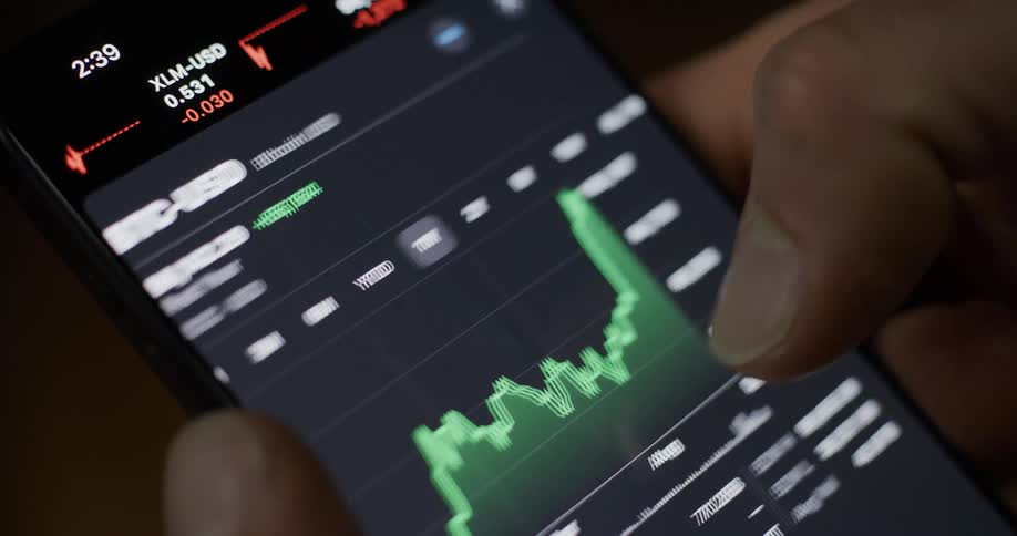 Man scrolls through financial data on a smartphone