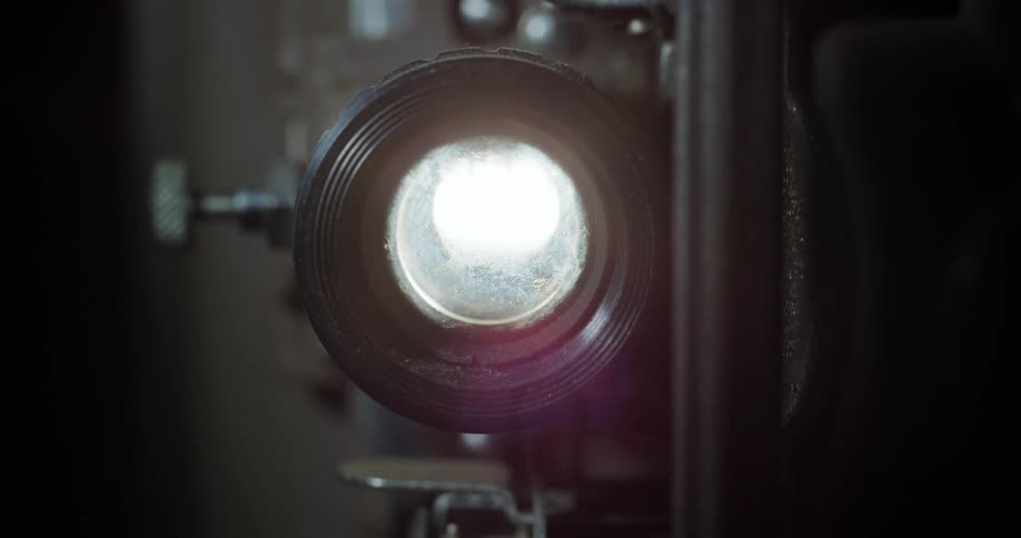 I camera lens is flashing a bright light in a dark room