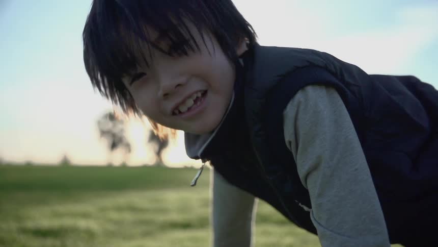 A young boy playing on the grass