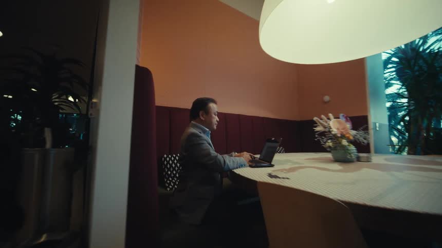 A clip of a man working in an open office space